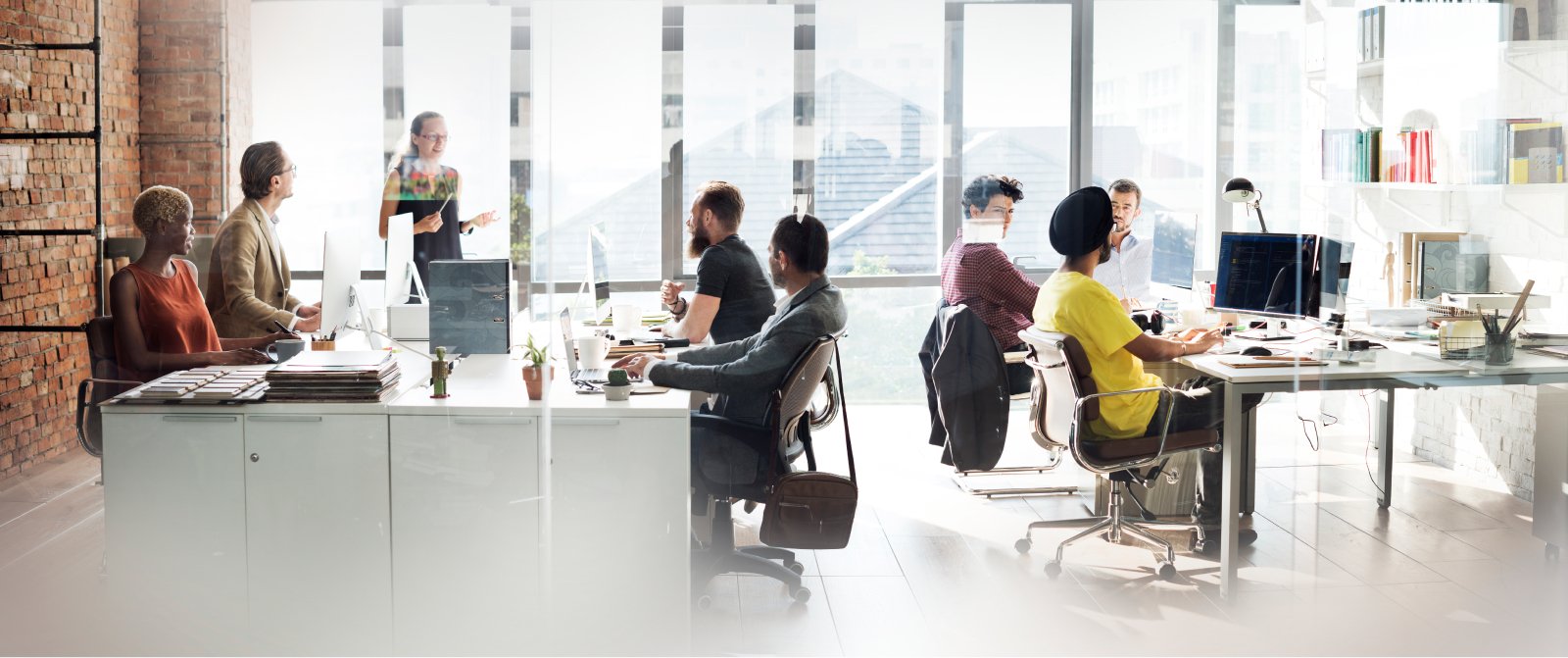 Team collaborates in a modern office, with a leader presenting on scaling and alignment for sustainable business growth.
