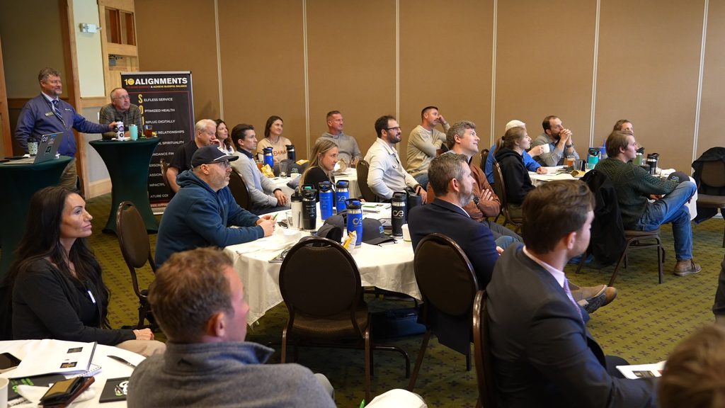 Professionals gathered in a conference room for leadership alignment and sustainable growth strategy.