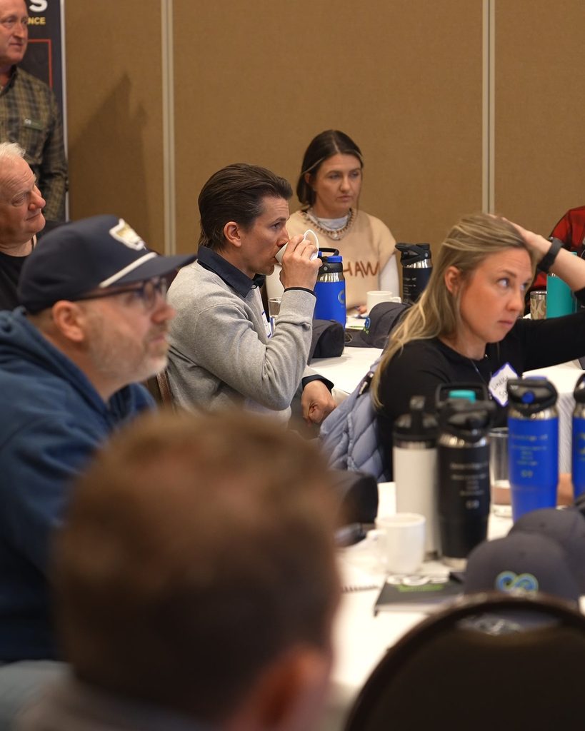 Leadership team engaged in a professional workshop focused on alignment and sustainable growth systems.