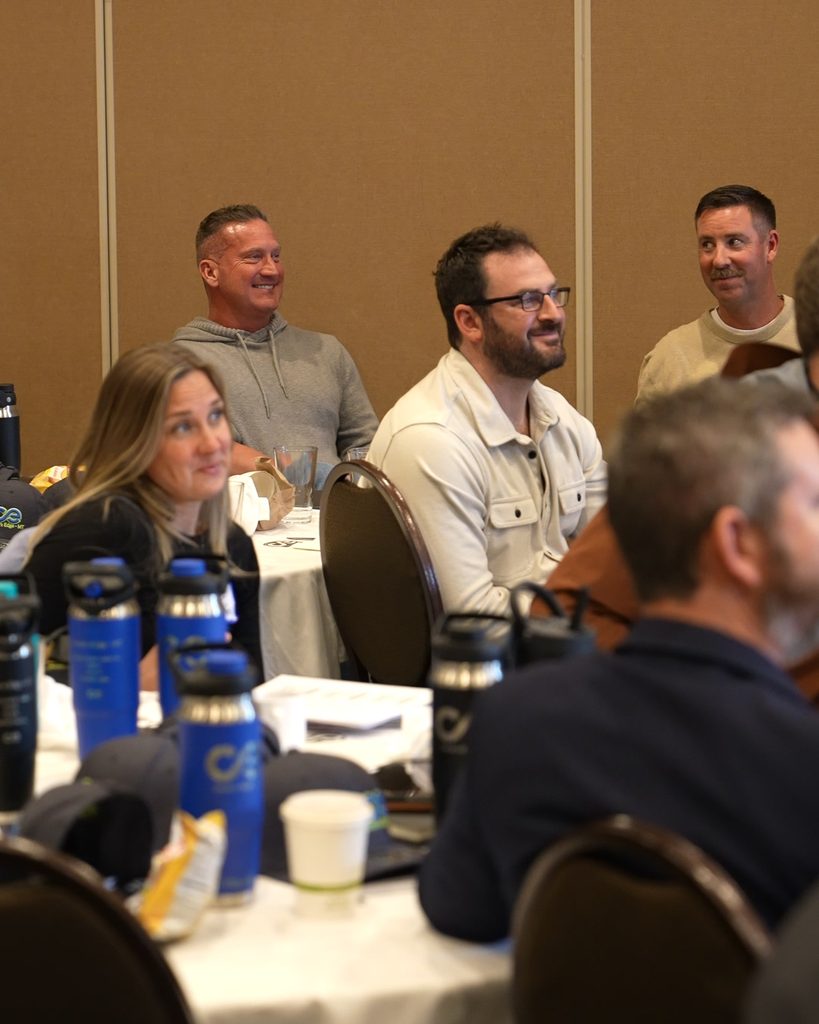 Professionals gathered for a leadership workshop to foster alignment and sustainable growth through systems thinking.