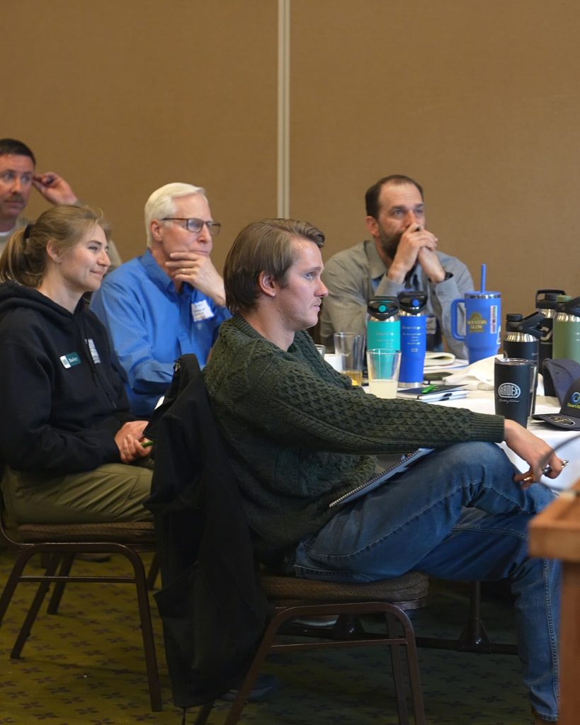 A team of professionals in a meeting focused on leadership alignment and sustainable growth.