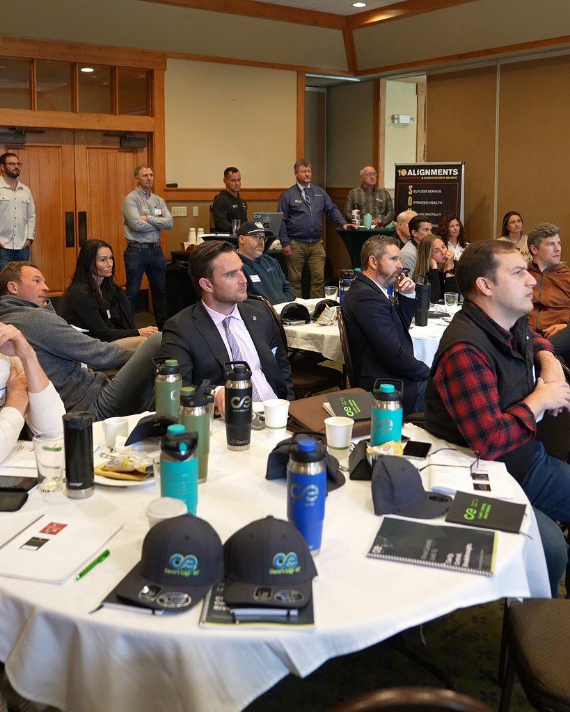 Professionals in a conference room focusing on leadership alignment and systems thinking for sustainable growth.