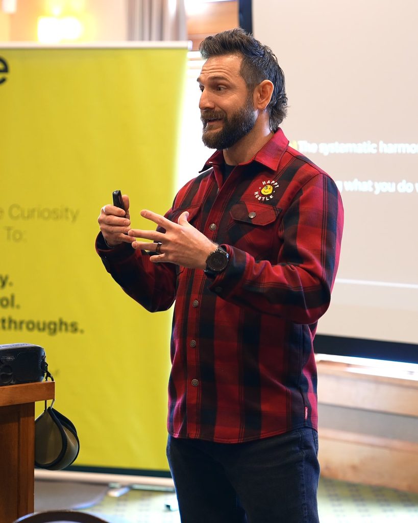 A leader in a flannel shirt presenting strategies for sustainable growth and organizational alignment.