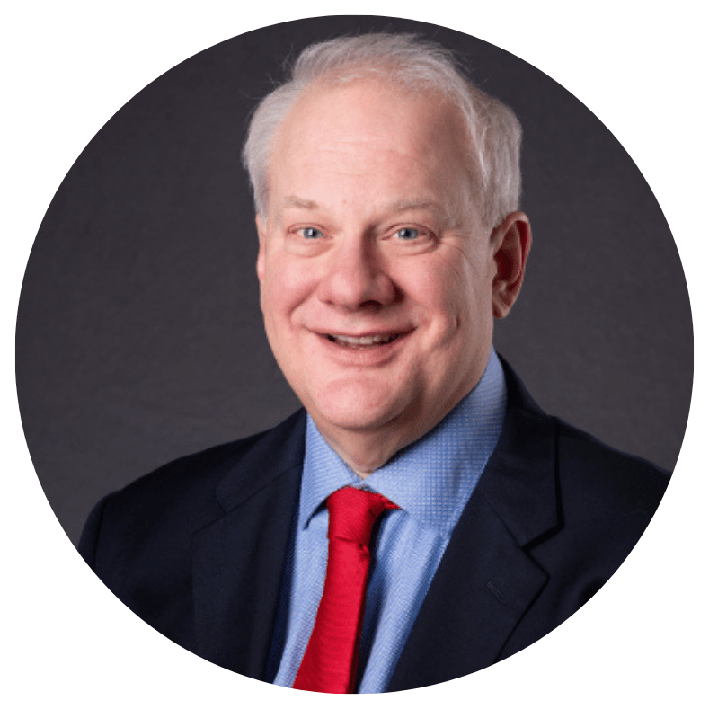 Professional middle-aged executive in a suit, light blue dress shirt, and red tie, embodying strategic leadership.