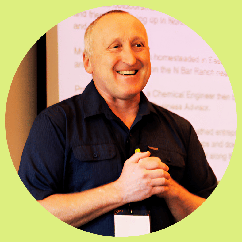 A leader in a dark shirt presents on systems thinking, driving sustainable growth and organizational alignment.